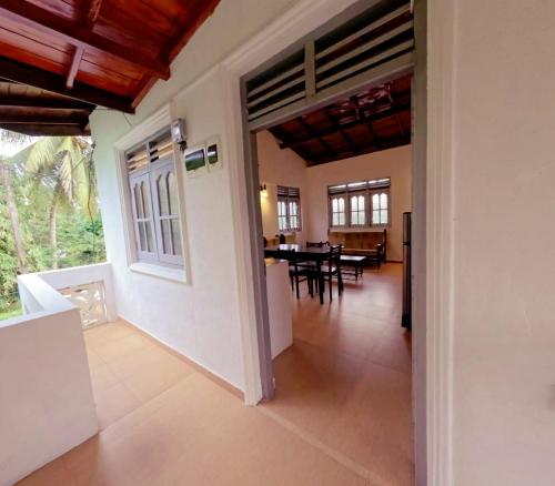 an open hallway with a dining room in a house at Susha Happy One First Floor Apartment in Hikkaduwa