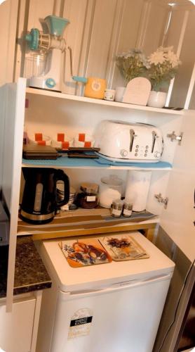 a refrigerator filled with lots of kitchen items at Private Bedroom and Large Deck Separate Entrance in Auckland