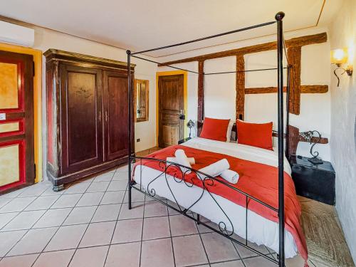 a bedroom with a bed with red pillows at Au Nid de Cigogne in Zellenberg