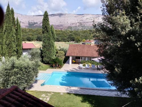 a swimming pool in a yard with a house at Villetta BLUE GARDEN in Sonnino