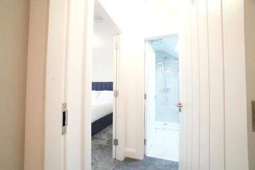 a bathroom with a door leading to a bedroom at The Lodge in Dunmore