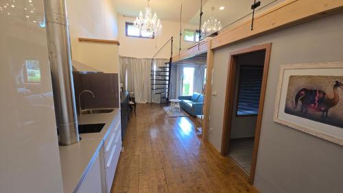 a kitchen and living room with a sink and a couch at Areal Botanika in Unhošť