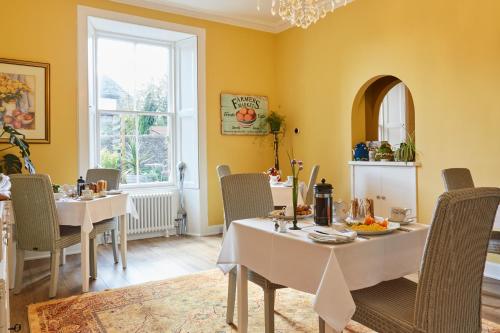 a dining room with tables and chairs and a window at Merlindale in Crieff