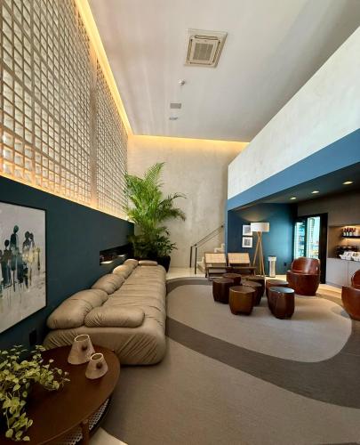 a living room with a large couch and a table at Bê Hotel in Sao Paulo