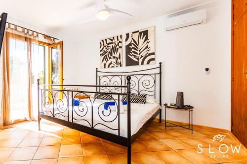 a bedroom with a bed in a room at Villa Ewa by Slow Villas in Cala Pi