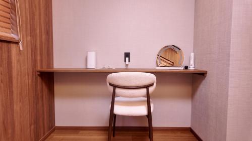 a stool sitting at a vanity with a mirror at Wabisabi Home official汐和 in Wada