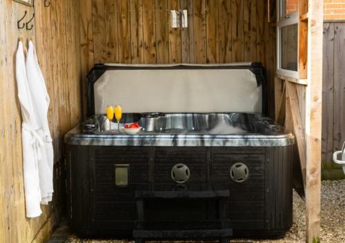 a bathroom with a sink in a wooden wall at 2 Bed House with Hot Tub Great Ayton - TOP House in Great Ayton