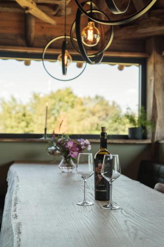 a bottle of wine sitting on a table with two glasses at Landgoed Boneman in Meddoo