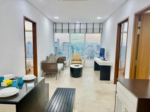 a large living room with a view of a city at Sky Apartment KLCC Suites in Kuala Lumpur