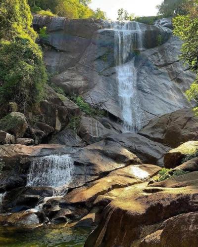 a waterfall on the side of a rocky mountain at AzYaa Homestay in Langkawi Islands