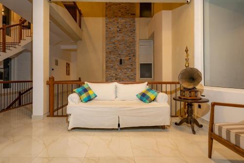 a living room with a white couch and a table at The Cloud Hanthana, Kandy in Kandy