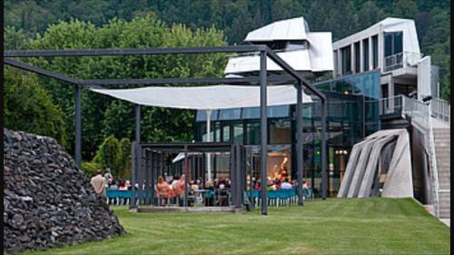 a large building with people sitting outside of it at Ferienhaus Silja in Steindorf am Ossiacher See