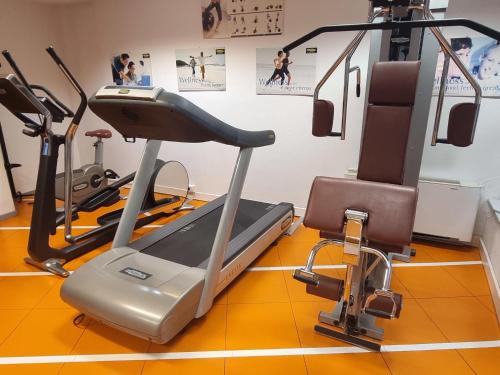 a gym with two tread machines and a treadmill at Novotel Firenze Nord Aeroporto in Sesto Fiorentino