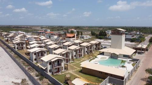 an aerial view of a resort with a swimming pool at Chale Lady Clara Encanto e Conforto nos Lencois MA in Santo Amaro