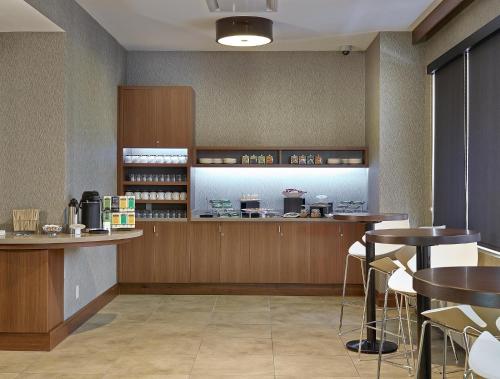 a restaurant with two tables and a counter in a room at DoubleTree by Hilton Hotel & Conference Centre Regina in Regina