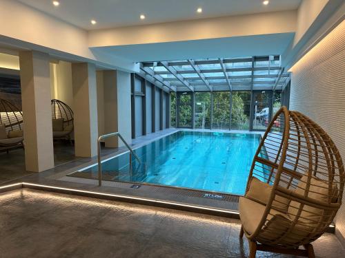 a large swimming pool with a chair next to it at Hotel Asgards Midgard in Zinnowitz