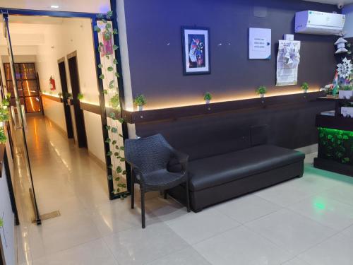 a waiting room with a couch and a chair at Nirvis Grand in Guwahati