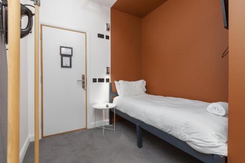 a small bedroom with a bed and a small table at ART B&B in Blackpool