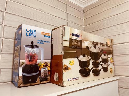 a food processor and a box sitting on a counter at A New Cozy Residential With Garden For Rent In Degla Palms Compound, 6th of Octobe in 6th Of October