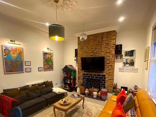 a living room with a couch and a fireplace at GENSING LODGE STUNNING SEASIDE MAISONETTE in St. Leonards