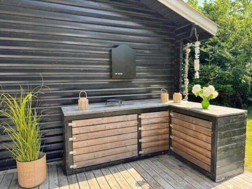 a outdoor kitchen with a sink on a patio at 10041-1-Rorvig-Langesovej-2 in Rørvig
