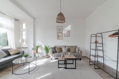 a living room with a couch and a table at SpaceStays Apartment For 4 in Bochum
