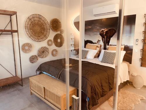 a room with a bed and a mirror at Mas LAOME Villa proche d'UZÈS in Saint-Just-et-Vacquières