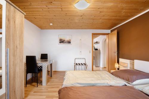 a bedroom with a bed and a desk at Ferienwohnung Annette in Gomadingen
