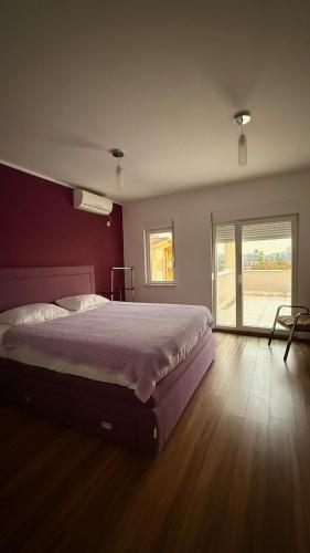 a bedroom with a large bed and a window at Villa Nadia in Bar