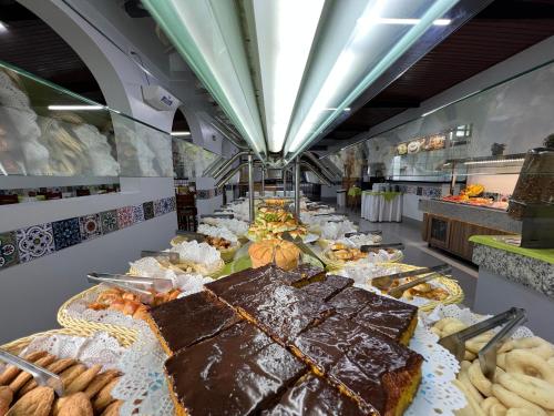 a buffet line of brownies and other pastries at Hotel Roma direto com o Grupo diRoma com acesso ao Acqua Park e Café da manhã in Caldas Novas