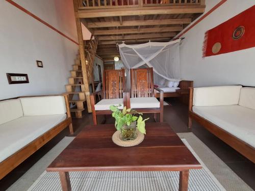 a room with two beds and a table at Gassy Country House Ivato Airport in Ivato