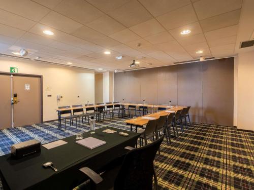 a conference room with a long table and chairs at Mercure Bordeaux Chateau Chartrons in Bordeaux
