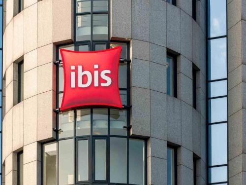 a red sign on the side of a building at ibis Koblenz City in Koblenz