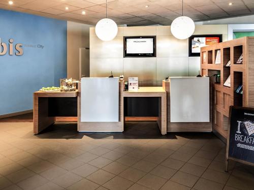 a restaurant with two refrigerators in a room at ibis Koblenz City in Koblenz