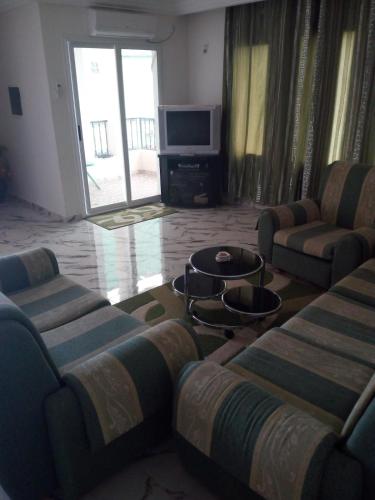a living room with two couches and a tv at Beautiful house rentals in Tabarka-Tunisia in Tabarka