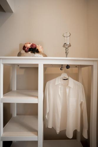 a white shelf with a white shirt on it at Borghi di Belmonte in Palermo