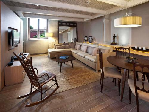 a living room with a couch and a table at Sofitel Legend Santa Clara Cartagena in Cartagena de Indias