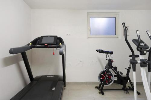 a gym with two exercise bikes in a room at Hotel Residence Olympia Sarntal in Sarntal