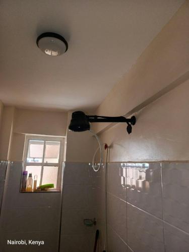 a bathroom with a light on the ceiling at Colokhaly Apartment in Nairobi