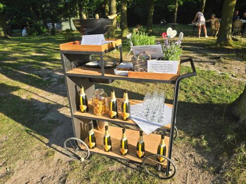 a display of wine bottles on a cart in a park at Areal Botanika in Unhošť
