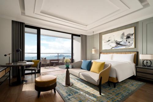 a bedroom with a bed and a living room at InterContinental Halong Bay Resort by IHG in Ha Long