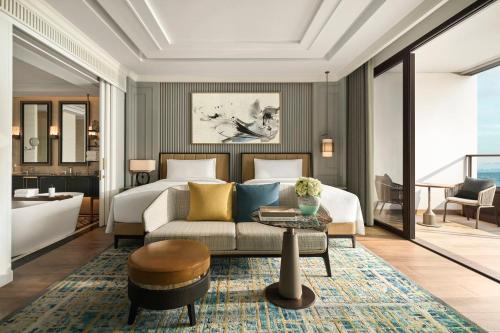 a hotel room with a bed and a couch at InterContinental Halong Bay Resort by IHG in Ha Long