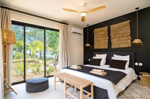 En eller flere senge i et værelse på Villa d exception au charme créole à l Ermitage