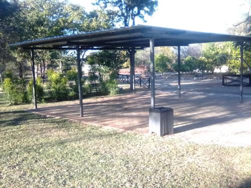 a pavilion in a park with a trash can at Munati B&B in Musina