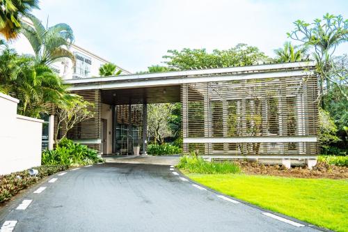 an external view of a house with a driveway at Holiday Inn Mauritius Mon Trésor by IHG in Blue Bay
