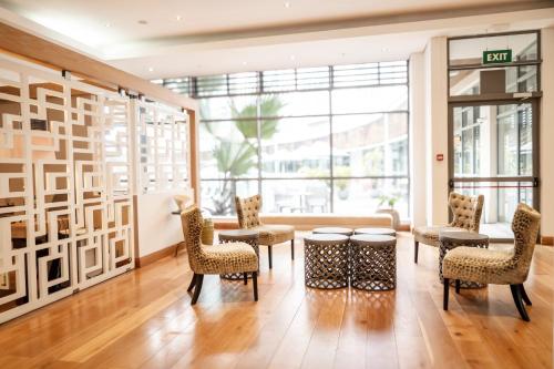 a room with tables and chairs and a large window at Holiday Inn Mauritius Mon Trésor by IHG in Blue Bay