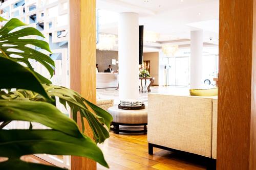 a lobby with a reception desk and a plant at Holiday Inn Mauritius Mon Trésor by IHG in Blue Bay