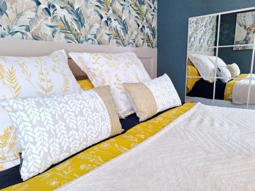 a bed with pillows on it in a bedroom at Duplex for 4 people in Folligny