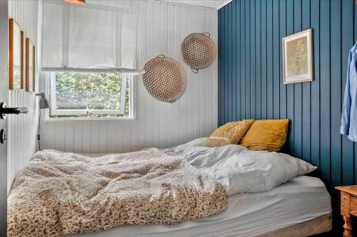 a bedroom with a bed and a blue wall at 30116-Odder-P-Baatrupsvej-47 in Beder