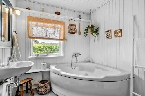 a white bathroom with a tub and a sink at 30116-Odder-P-Baatrupsvej-47 in Beder